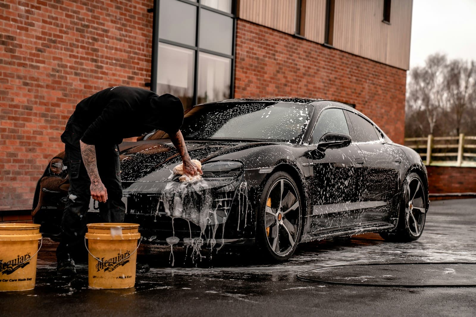 Professional detailing process on a vehicle exterior
